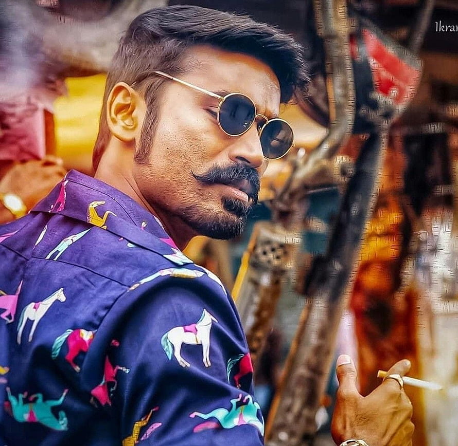 Dhanush in Maari wearing round sunglasses and a colorful horse-patterned shirt HD wallpaper