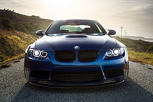 Front View of a Blue BMW M3 E92 Coupe Parked on a Gravel Road at Sunset HD wallpaper