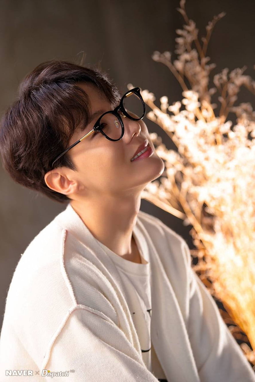 J-Hope from BTS in a warm portrait wearing round glasses and a cream knit cardigan HD phone wallpaper