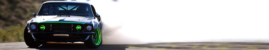 Classic Muscle Car Drifting on Track with Green Neon Accents and Tire Smoke HD wallpaper