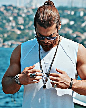 Can Yaman Wearing Sunglasses And Jewelry On A Boat With Coastal City View HD phone wallpaper