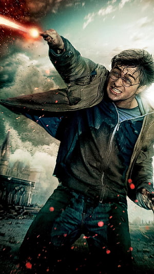 Harry Potter Casting a Spell Amidst Battle Debris and Smoke in a Cinematic Action Scene HD phone wallpaper