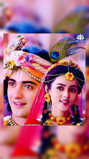 Radhe Krishna in ornate traditional Indian attire with peacock feather and floral jewelry HD phone wallpaper