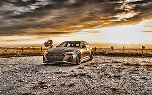 Audi RS6 Avant Matte Black Wagon Parked in Open Field at Golden Sunset HD wallpaper