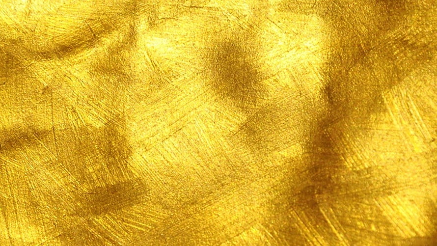Luxurious Textured Gold Surface with Brushed Metallic Finish and Warm Amber Tones HD wallpaper