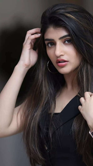 Sreeleela Portrait in Black Blazer with Long Dark Hair and Gold Hoop Earrings HD phone wallpaper