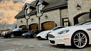 Luxury Supercars Parked in Front of a Stone Mansion at Dusk HD wallpaper