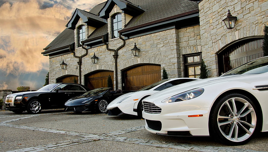 Luxury Supercars Parked in Front of a Stone Mansion at Dusk HD wallpaper