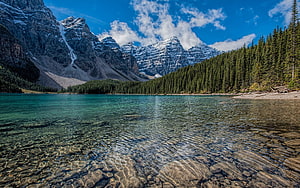 Turquoise Mountain Lake with Snow-Capped Peaks and Dense Evergreen Forest HD wallpaper