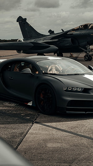 Matte Black Bugatti Chiron Parked on Airfield Tarmac with Military Jet HD phone wallpaper