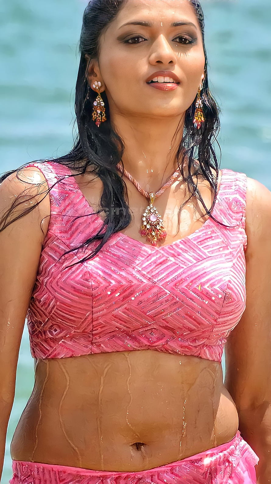Sunaina in a pink patterned crop top and skirt at the beach with wet hair and jewelry HD phone wallpaper