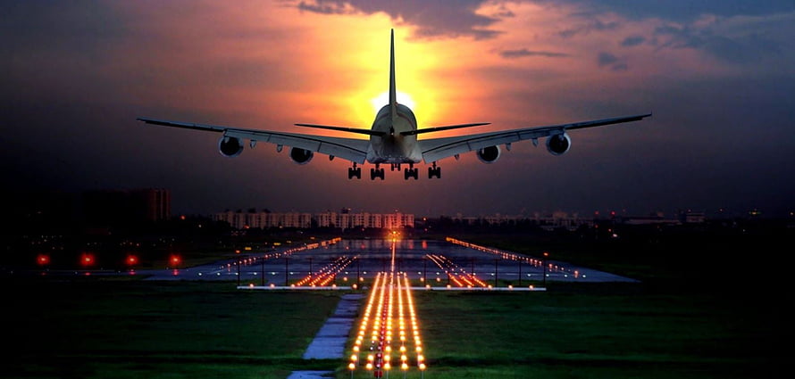 Large Commercial Airplane Landing on Runway at Sunset with Illuminated Approach Lights HD wallpaper
