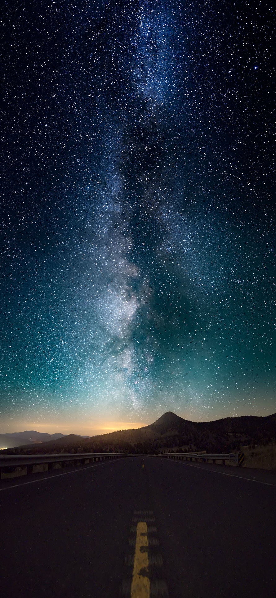 Milky Way Galaxy Arching Over a Desert Highway at Night with Distant Mountains HD phone wallpaper