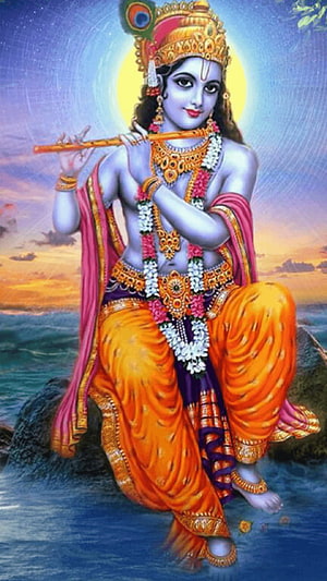 Lord Krishna Playing Flute by the Water at Sunset with Peacock Crown and Floral Garlands HD phone wallpaper