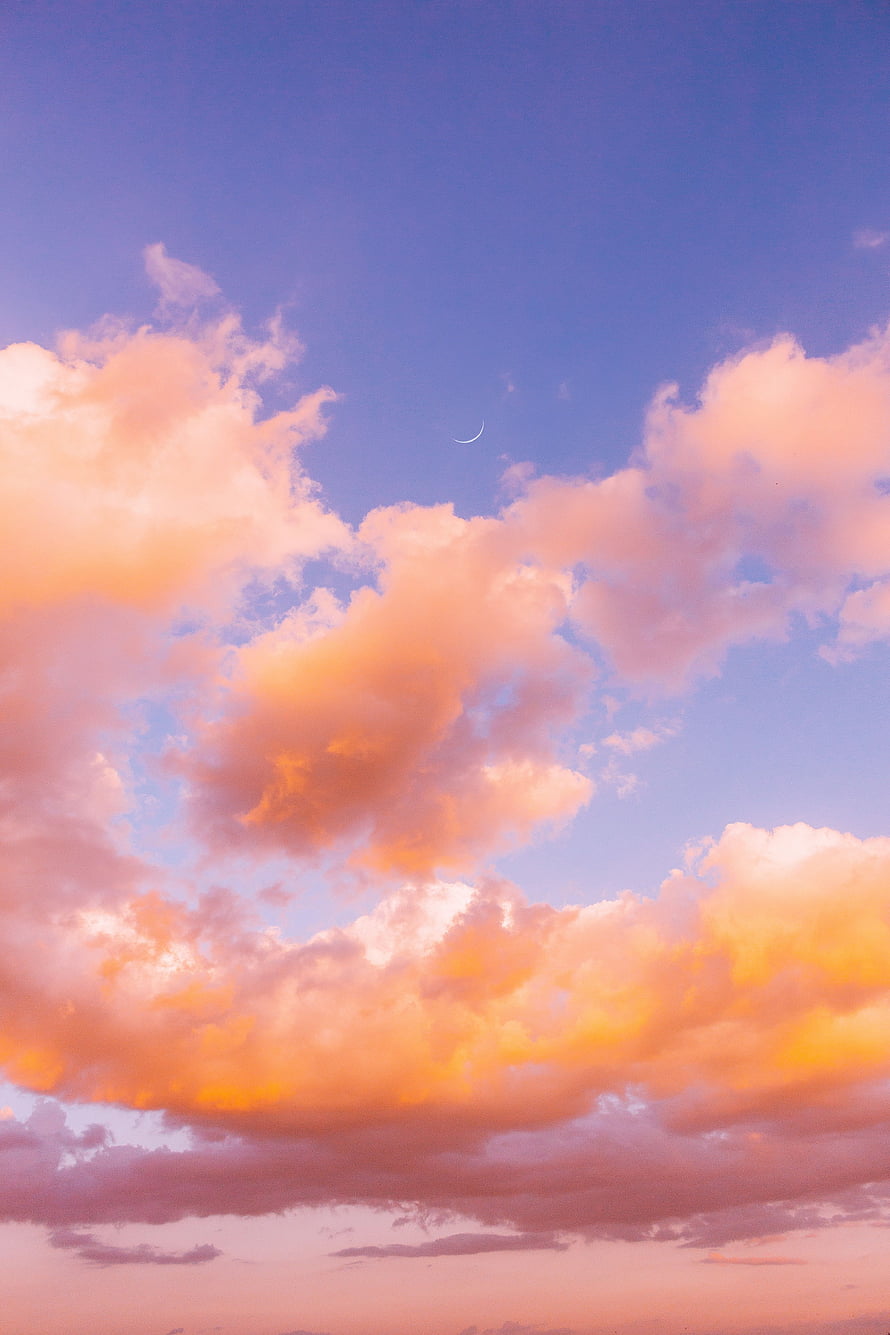 Crescent Moon Above Vibrant Sunset Clouds in a Soft Blue and Orange Sky HD phone wallpaper