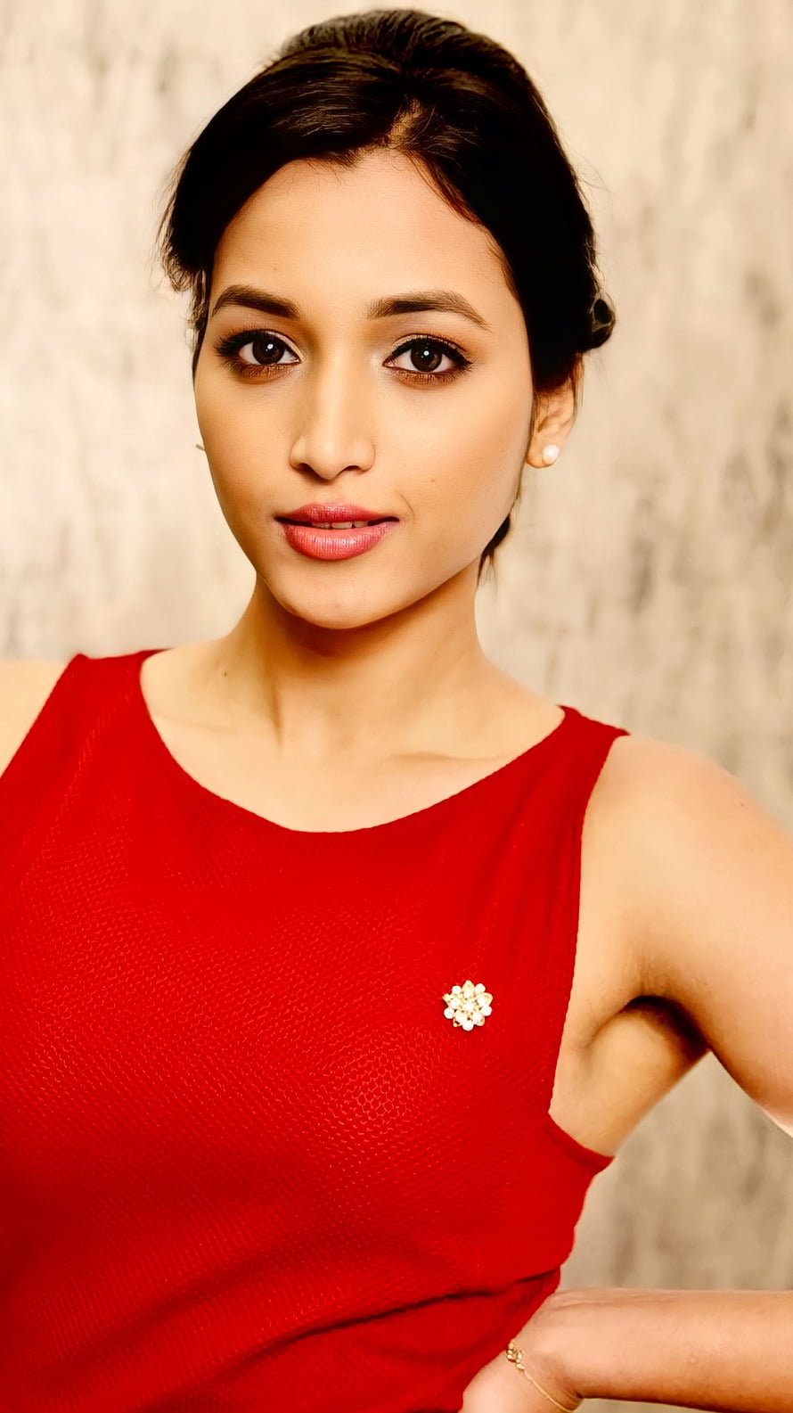 Srinidhi Shetty in a Red Sleeveless Top with Floral Brooch and Pearl Earring HD phone wallpaper