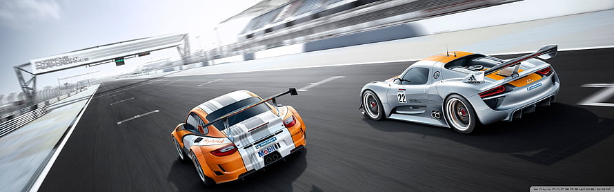 Two Porsche 918 Spyder race cars speeding on a professional circuit track HD wallpaper