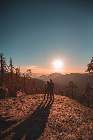 Couple Silhouette on Rocky Outcrop at Golden Hour in Sequoia National Park HD phone wallpaper