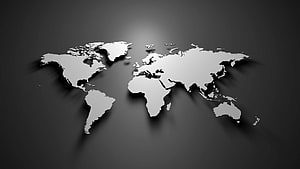 Monochrome 3D World Map with Soft Drop Shadows on Dark Gradient Background HD wallpaper