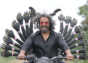 Vikram as the multi-armed demon character on a motorcycle in the film Mahaan HD wallpaper