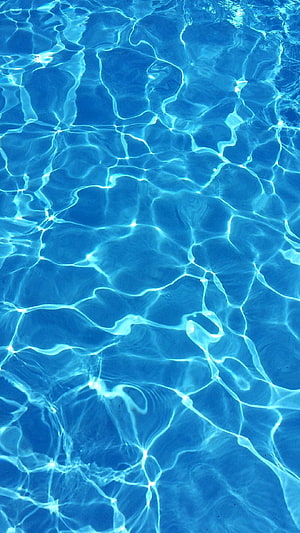 Cascading Blue Water Ripples with Bright Sunlight Reflections and Caustic Patterns HD phone wallpaper