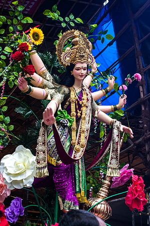Ornate Durga Maa Idol Adorned in Purple Saree with Flowers and Gold Jewelry HD phone wallpaper
