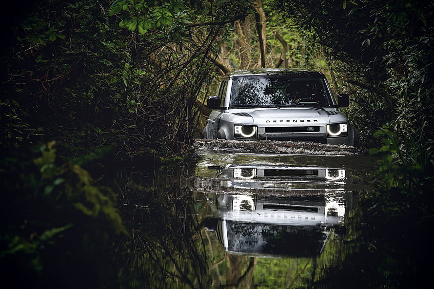 Land Rover Defender Forging Through a Forest Stream With Mirror Reflection HD wallpaper