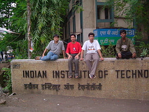 Four Students Sitting on the Indian Institute of Technology Bombay Signage Wall HD wallpaper