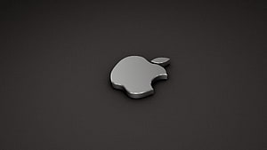 Sleek 3D Apple Logo Emblem on Dark Matte Surface HD wallpaper