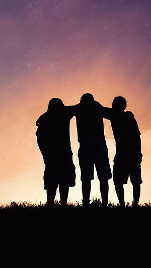Three friends standing together in silhouette against a vibrant sunset sky HD phone wallpaper
