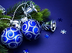 Blue Christmas Ornaments with Silver Bells and Pine Branches on a Deep Blue Background HD wallpaper