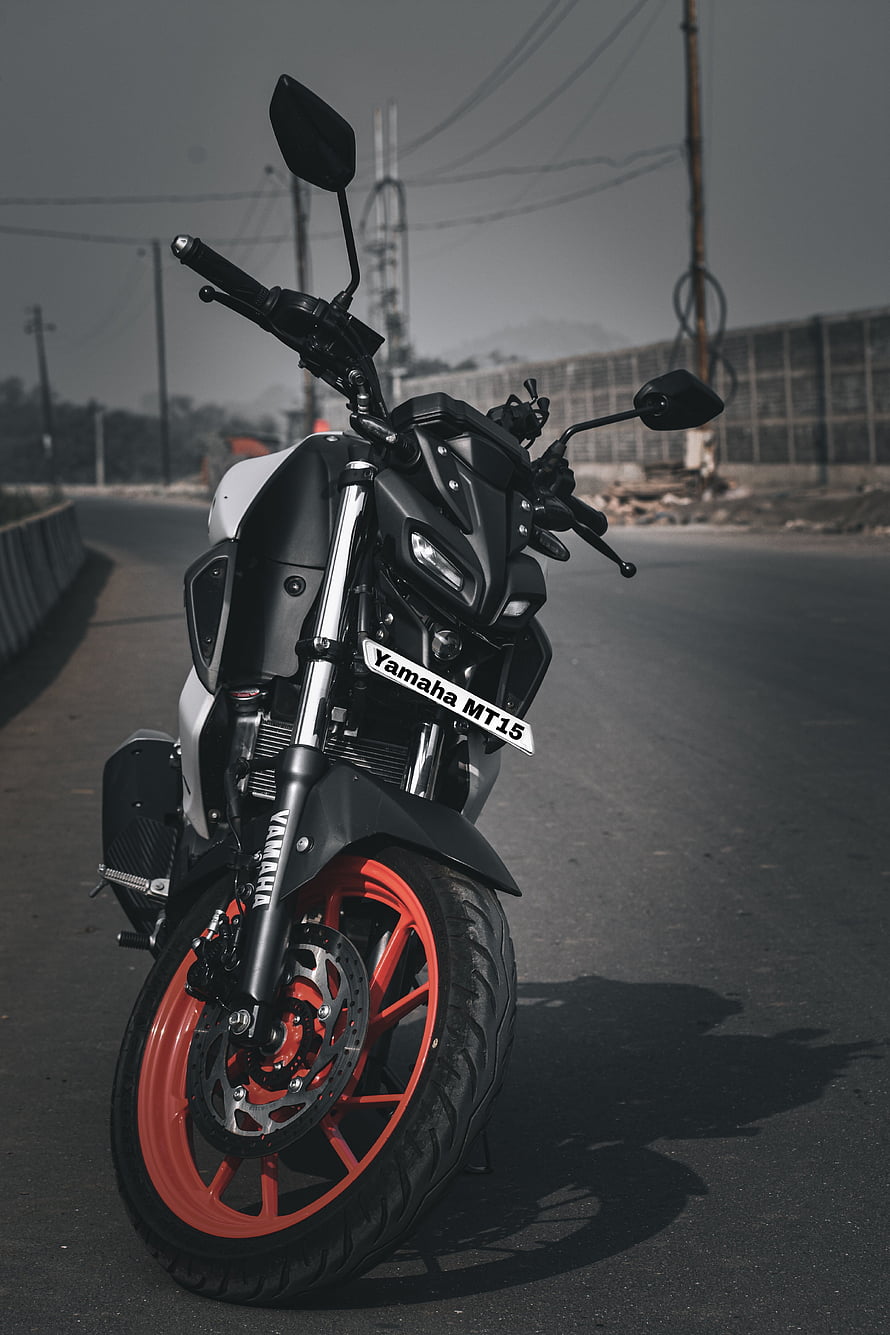 Yamaha MT-15 Motorcycle with Red Rims Parked on an Open Road HD phone wallpaper
