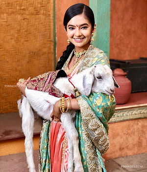 Anushka Sen in Traditional Indian Attire Holding a White Goat HD phone wallpaper