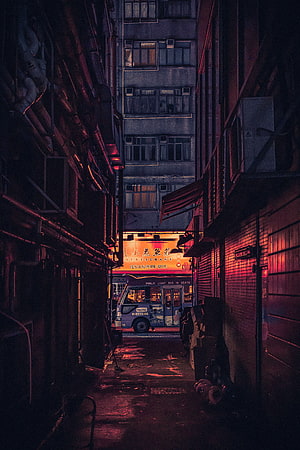 Moody Urban Alleyway at Night with Neon Restaurant Sign and Parked Bus HD phone wallpaper
