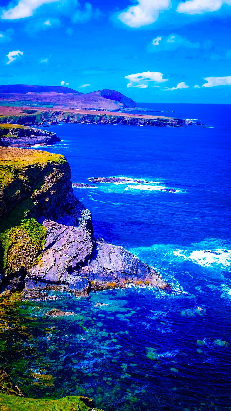 Dramatic Coastal Cliffs and Turquoise Ocean Waters Under a Bright Blue Sky HD phone wallpaper