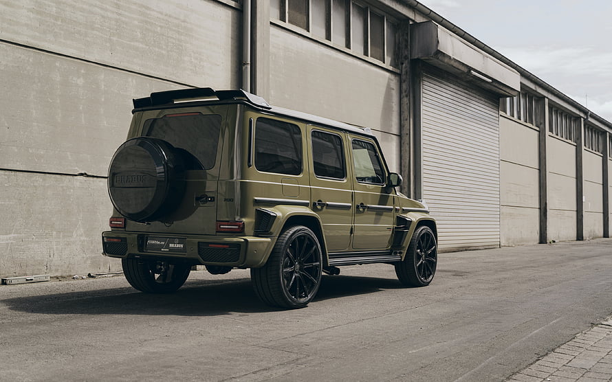 Brabus 700 Modified Mercedes G-Class SUV in Olive Green Parked in Industrial Yard HD wallpaper