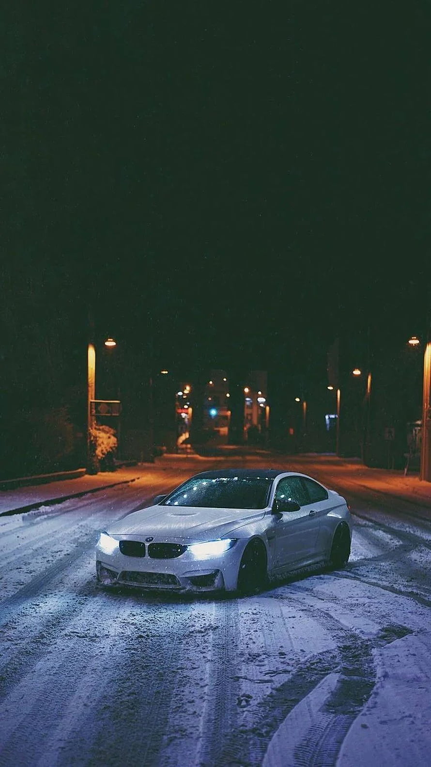 White BMW M4 Coupe Parked on Snowy Street at Night with Glowing Headlights HD phone wallpaper