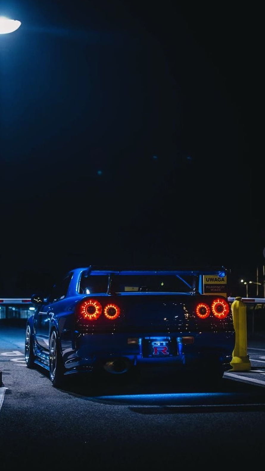 Nissan Skyline GT-R R34 Rear View at Night with Glowing Taillights HD phone wallpaper