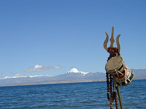 Sacred Mount Kailash Viewed Across Lake Manasarovar with Tibetan Ritual Drum HD wallpaper