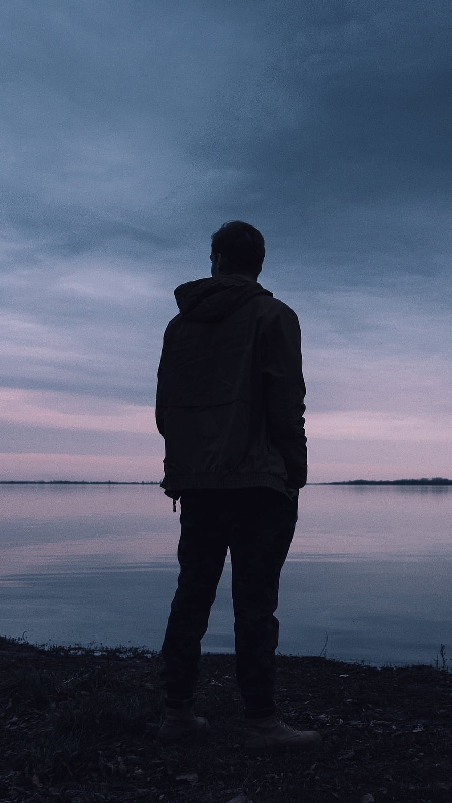 Solitary Figure Standing by a Calm Lake at Dusk HD phone wallpaper