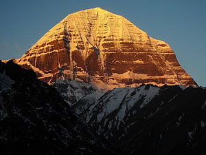 Mount Kailash at Golden Hour with Snow-Capped Summit and Dramatic Strata HD wallpaper