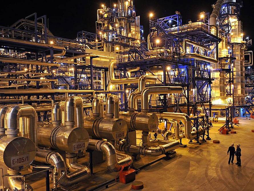 Illuminated Oil Refinery Complex at Night with Industrial Piping and Storage Tanks HD wallpaper