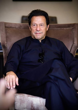 Imran Khan Seated in a Dark Traditional Shalwar Kameez with Sunglasses HD phone wallpaper
