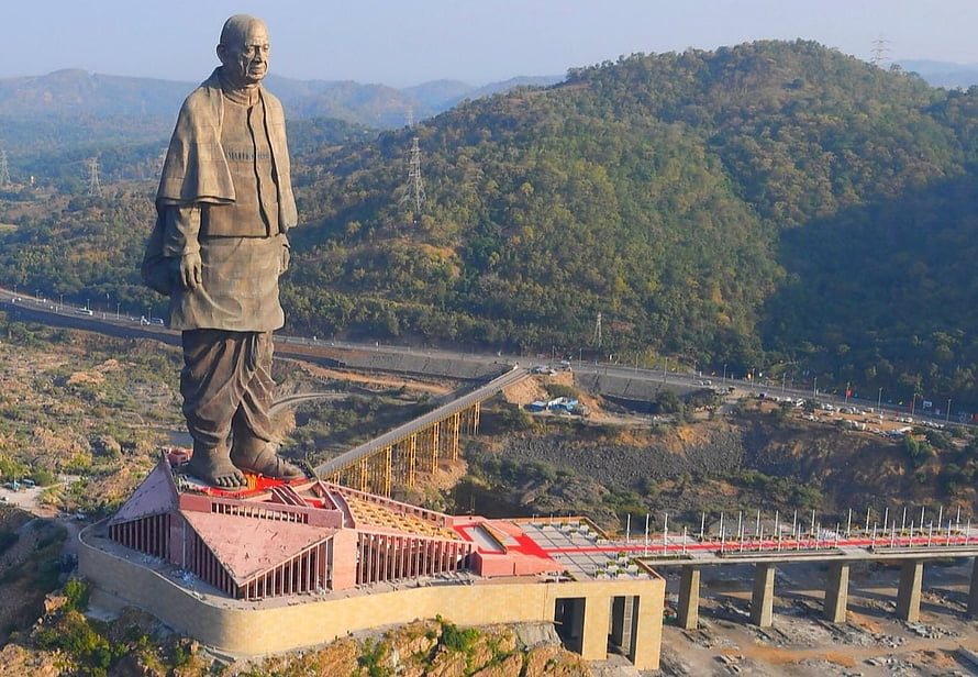 Statue of Unity overlooking the Narmada River valley and surrounding green hills HD wallpaper