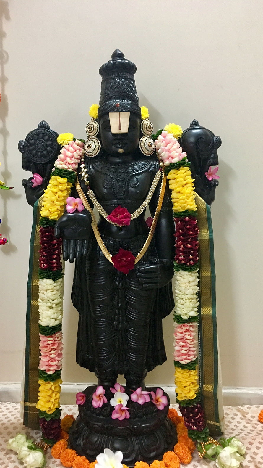 Black Stone Venkateshwara Murti Adorned With Colorful Flower Garlands And Temple Jewelry HD phone wallpaper