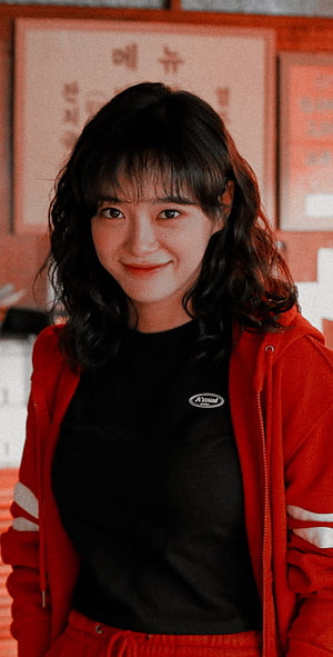 Kim Sejeong in a red hoodie and black top with a warm smile HD phone wallpaper