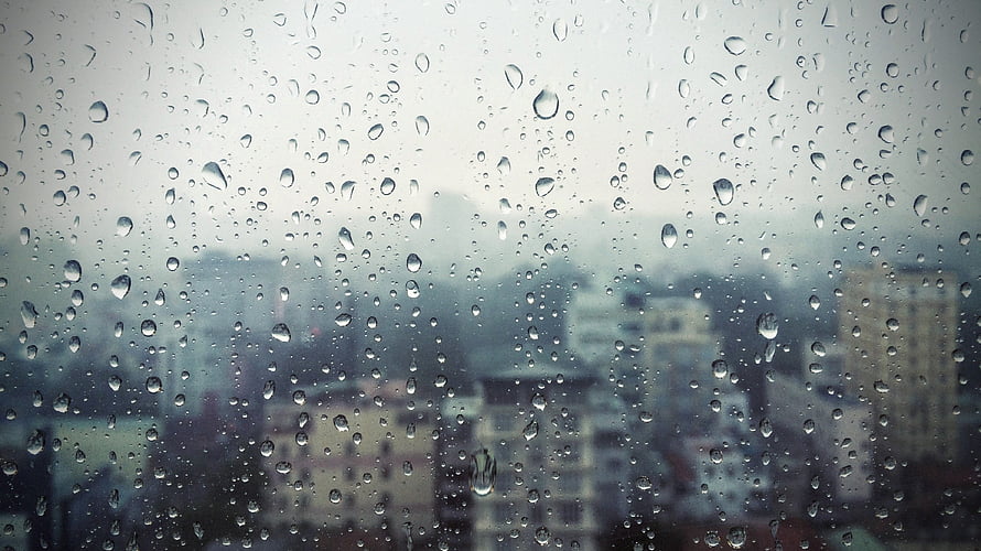 Moody Urban Skyline View Through Rain-Streaked Window Glass HD wallpaper
