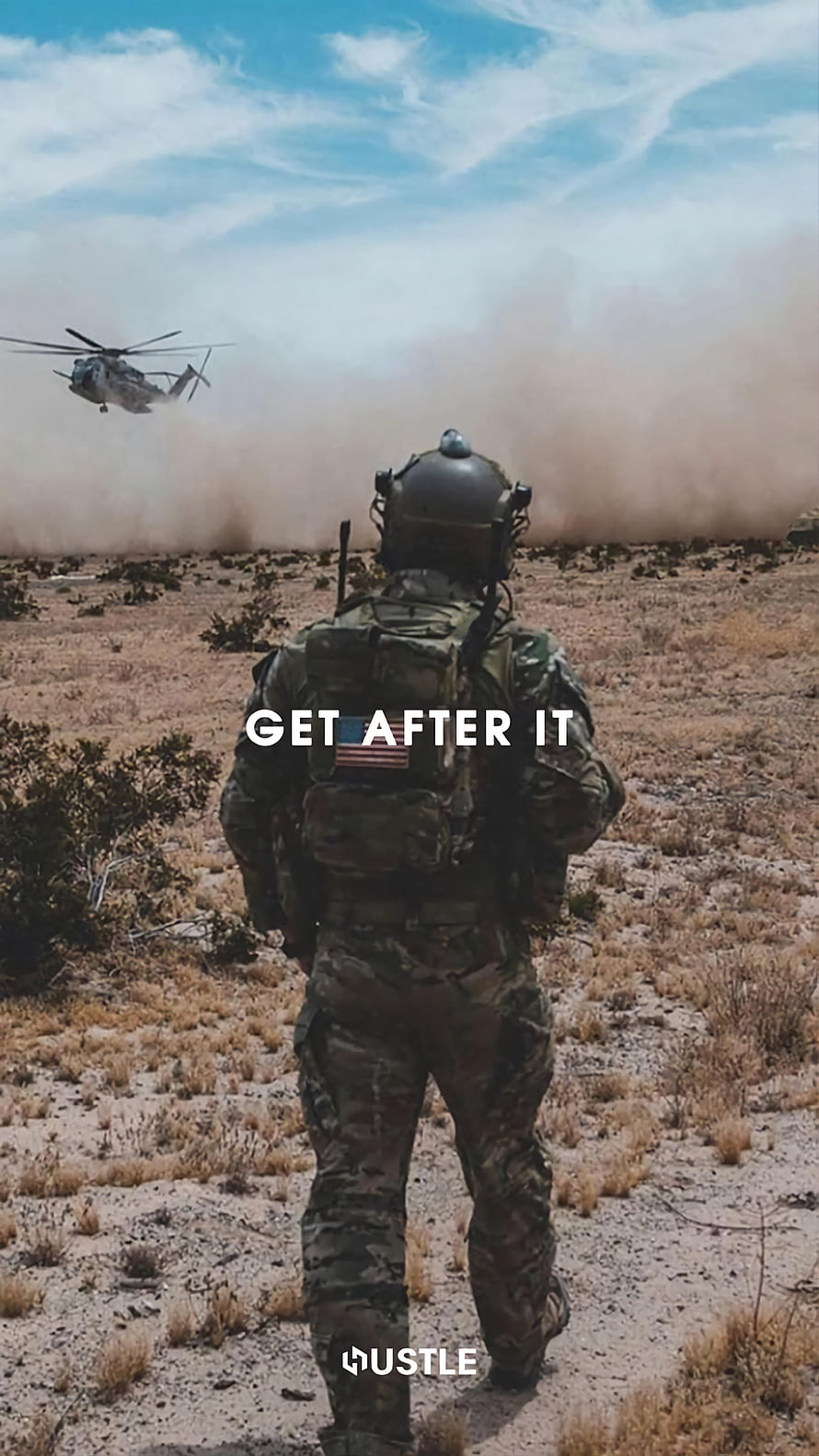 Soldier in Camouflage Gear Walking Through Desert with Helicopter in Background HD phone wallpaper