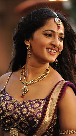 Anushka Shetty in Traditional Indian Bridal Attire with Gold Jewelry and Purple Saree HD phone wallpaper