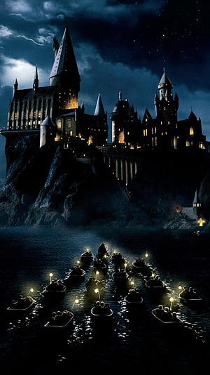 Hogwarts Castle at Night with First Year Boats Crossing the Dark Lake HD phone wallpaper